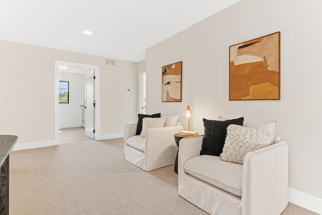 sitting room featuring light carpet