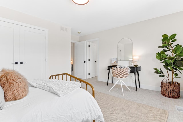 bedroom with a closet and light carpet