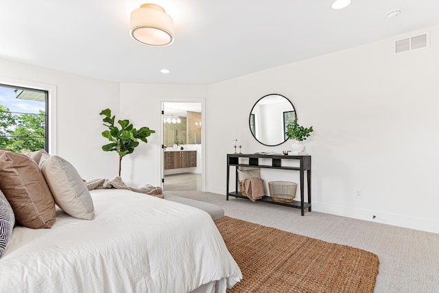 carpeted bedroom featuring connected bathroom