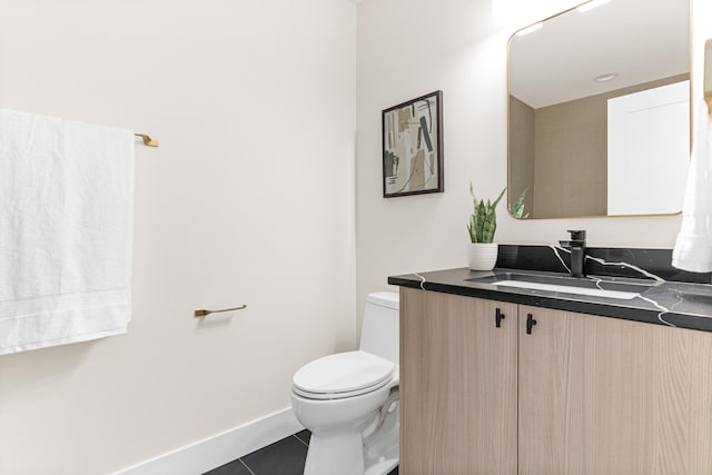 bathroom featuring toilet, tile patterned floors, and vanity