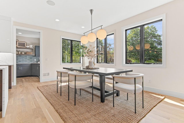 dining area featuring a wealth of natural light and light hardwood / wood-style flooring