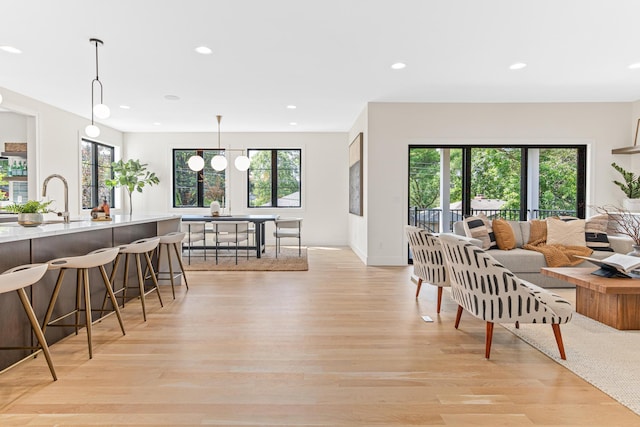 interior space with light hardwood / wood-style floors, an inviting chandelier, and sink