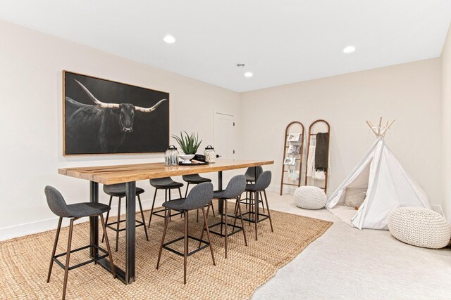 dining area with light colored carpet