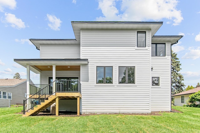 rear view of property featuring a yard