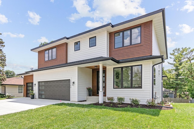 view of front of property featuring a front yard and a garage