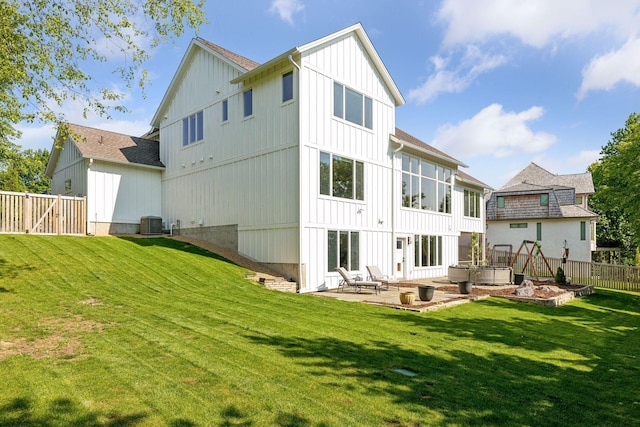 back of property featuring a lawn, central AC, and a patio