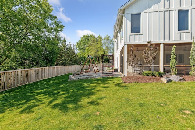 view of yard with a playground, a sunroom, and a patio