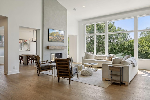 living room featuring a large fireplace and hardwood / wood-style floors