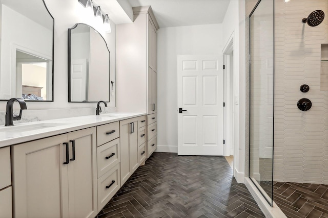 bathroom featuring tiled shower, vanity, and parquet flooring