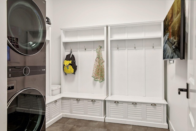 mudroom featuring stacked washer / drying machine