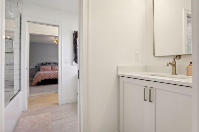 bathroom with combined bath / shower with glass door and vanity