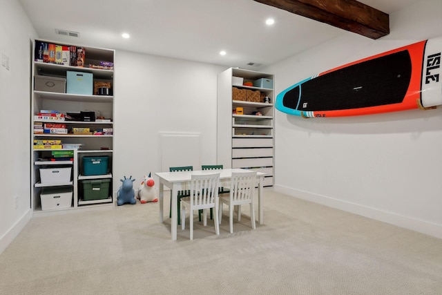 recreation room with beam ceiling and light colored carpet