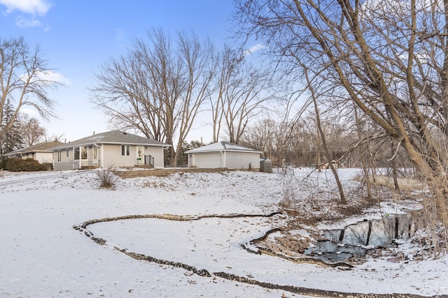 snowy yard featuring a garage