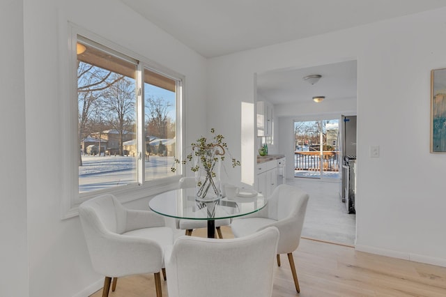 dining space with light wood-type flooring