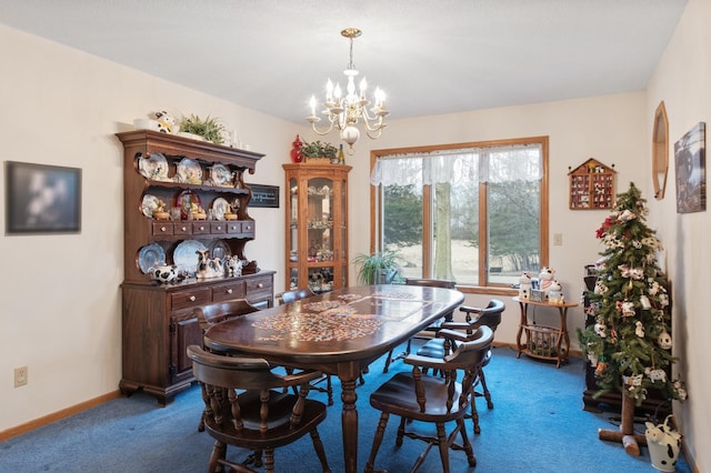 dining room with carpet flooring and a notable chandelier