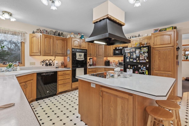 kitchen with sink, a center island, island range hood, black appliances, and a kitchen bar