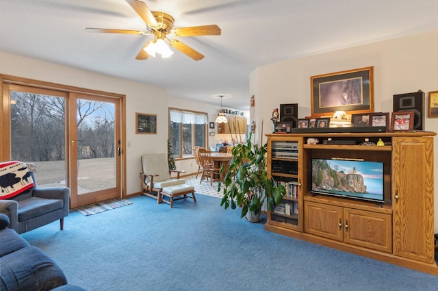 living room with ceiling fan and carpet flooring