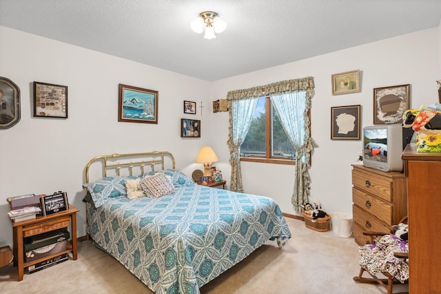 carpeted bedroom featuring a textured ceiling