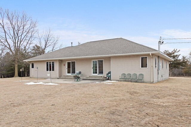 rear view of house with a patio and a lawn