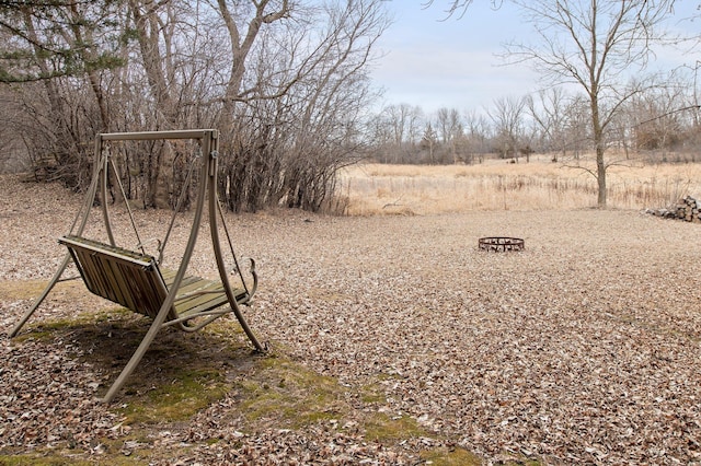 view of yard with an outdoor fire pit