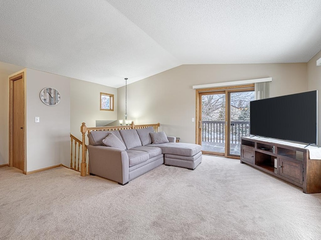 living room with light colored carpet, lofted ceiling, and a textured ceiling