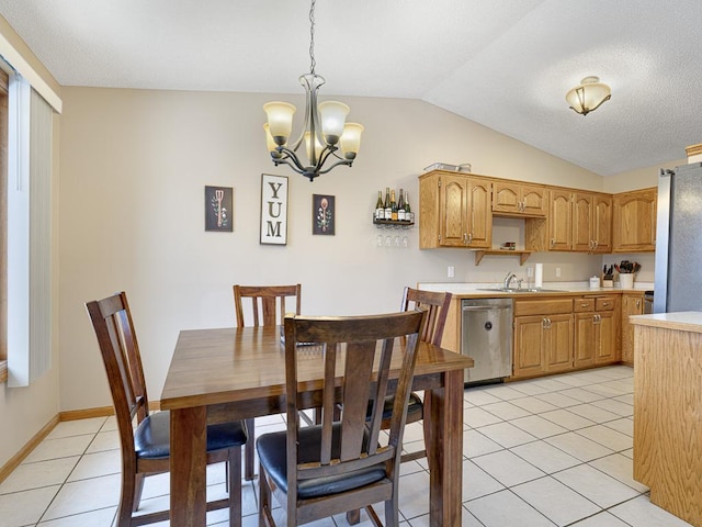 dining room featuring light tile patterned flooring, lofted ceiling, sink, and a chandelier