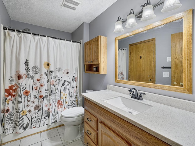 bathroom featuring vanity, walk in shower, toilet, tile patterned floors, and a textured ceiling