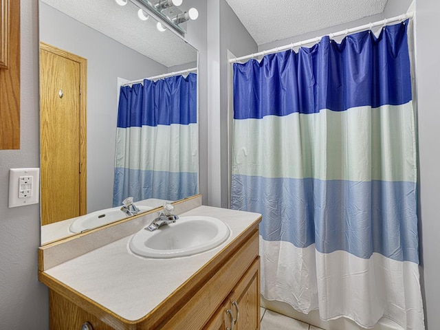 bathroom featuring vanity, a textured ceiling, and a shower with shower curtain