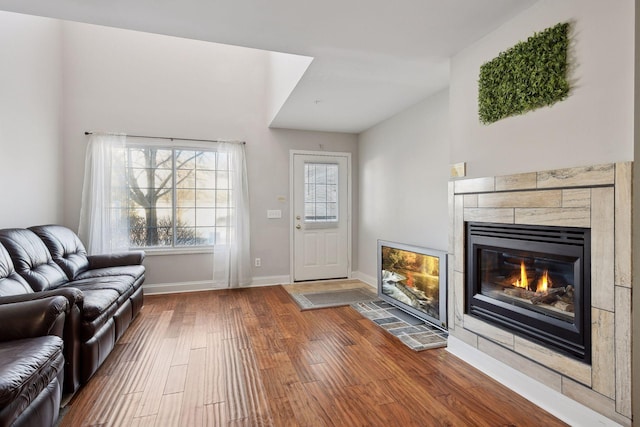 living room with hardwood / wood-style floors and a tile fireplace