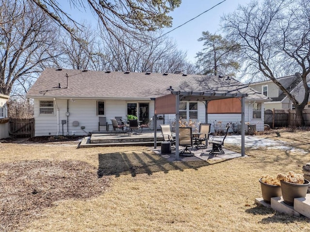 back of property featuring a patio area, roof with shingles, a pergola, and fence