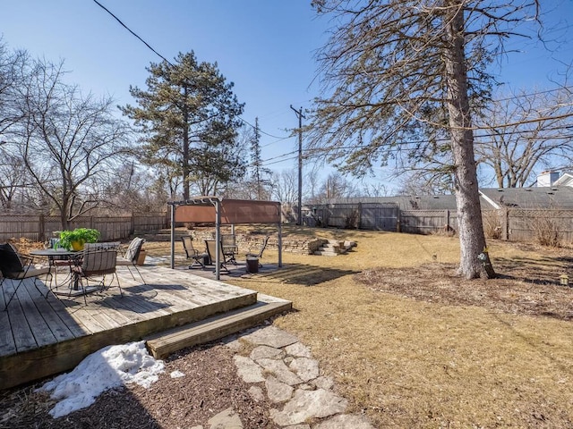 view of yard featuring a fenced backyard and a wooden deck