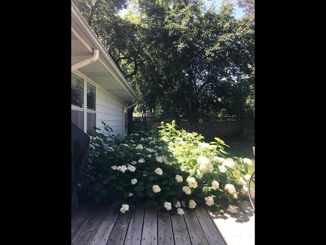 wooden terrace featuring fence