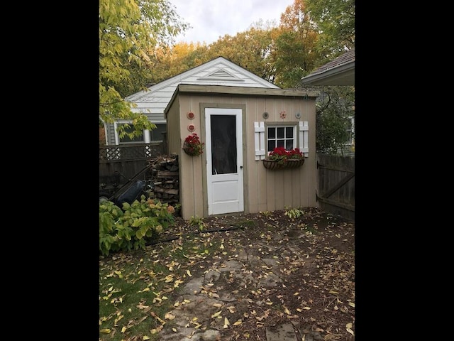 view of shed featuring fence