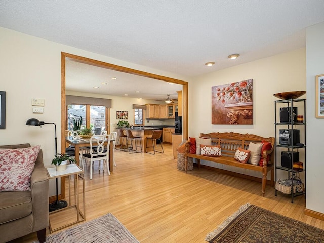 living room with recessed lighting and light wood-style flooring