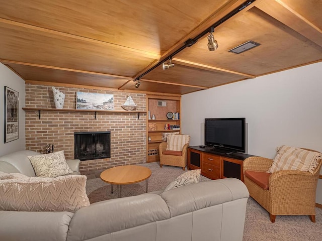 living room with visible vents, wood ceiling, light carpet, a fireplace, and rail lighting