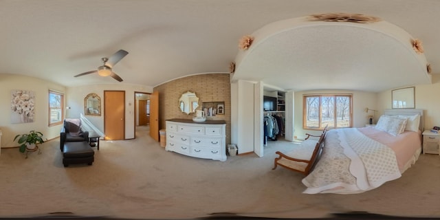 carpeted bedroom with lofted ceiling, multiple windows, and ceiling fan