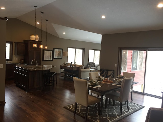 dining area with dark wood-type flooring and lofted ceiling