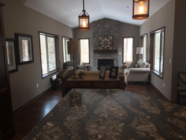 living room with dark hardwood / wood-style flooring, lofted ceiling, and a fireplace