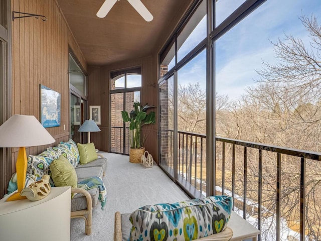 sunroom / solarium featuring ceiling fan