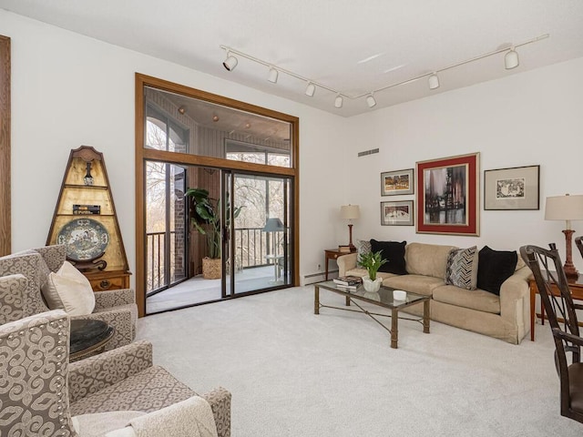 carpeted living room featuring a baseboard radiator