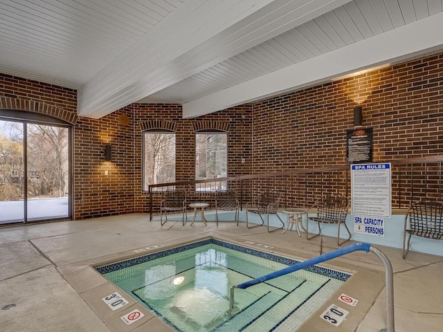 view of swimming pool with an indoor hot tub