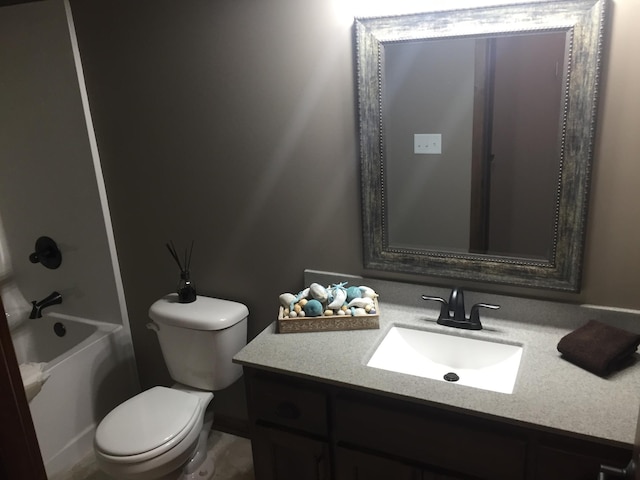 full bathroom featuring washtub / shower combination, vanity, and toilet