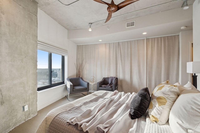 bedroom with track lighting and ceiling fan