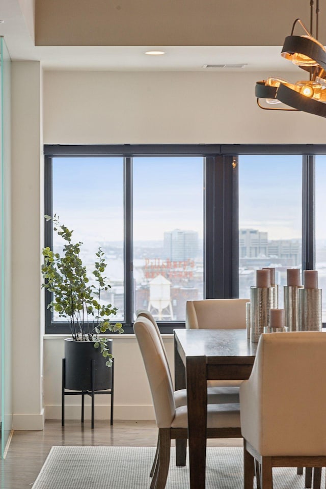 dining space with wood-type flooring