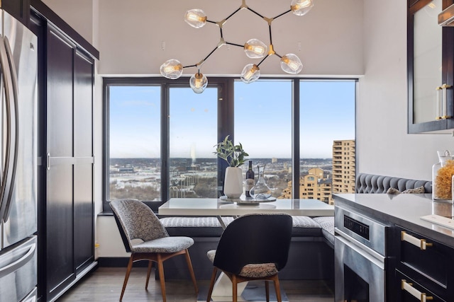 dining room with breakfast area, wood-type flooring, and plenty of natural light