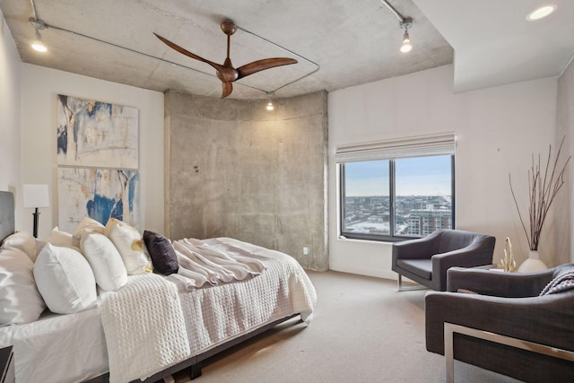 bedroom with ceiling fan, track lighting, and carpet