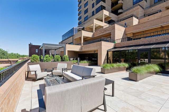 view of patio / terrace featuring an outdoor living space with a fire pit