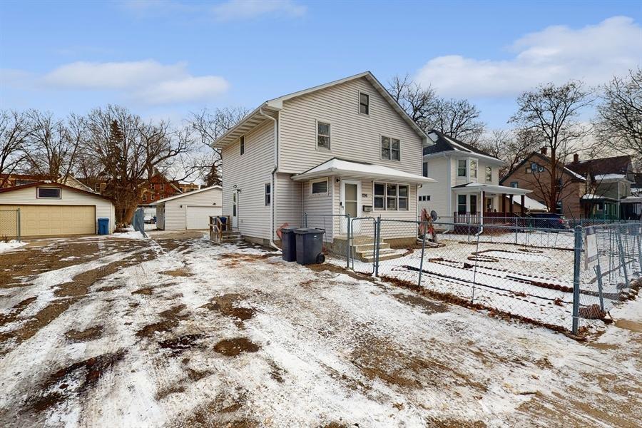 snow covered property with an outbuilding and a garage