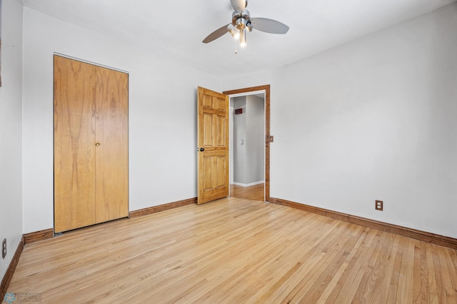 unfurnished bedroom featuring ceiling fan, light hardwood / wood-style flooring, and a closet