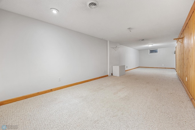 carpeted empty room featuring a textured ceiling